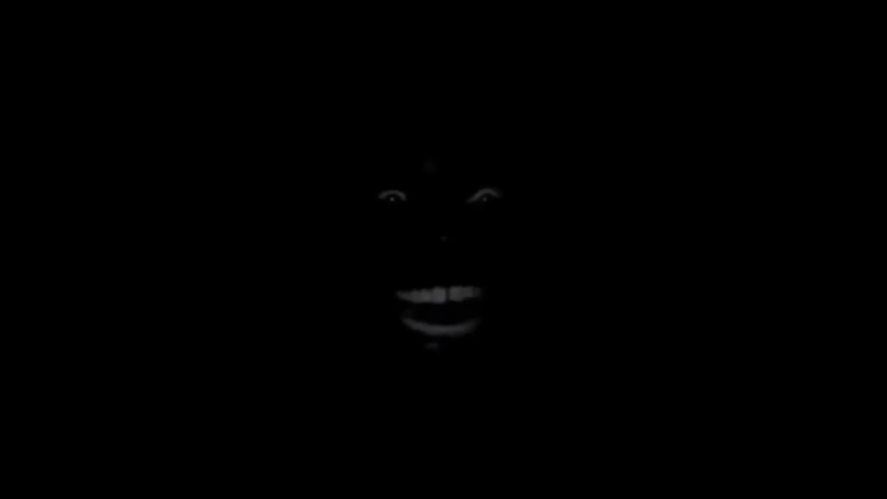 Black man laugh in the dark room