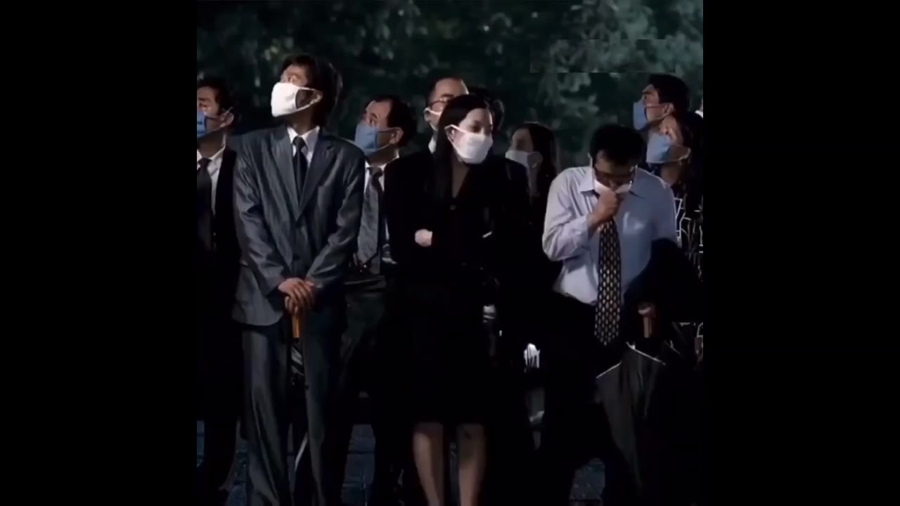Car Rushes Past Standing Crowd