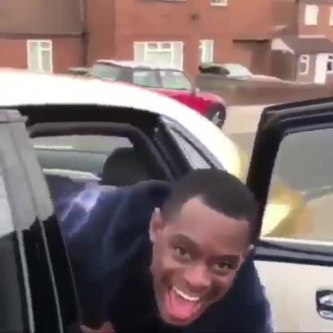 Man laughing getting into car