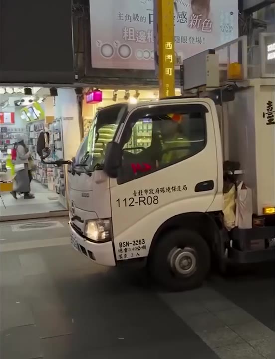 People Walking Past Truck