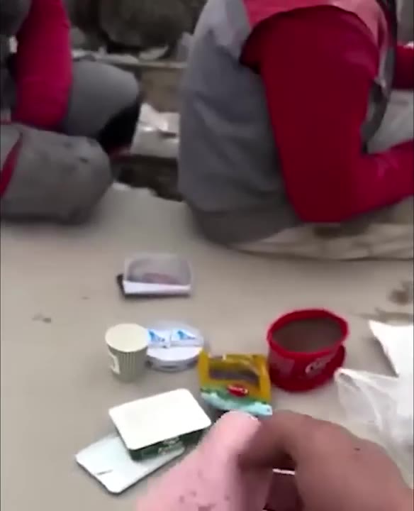 Person Examines And Picks From Ground