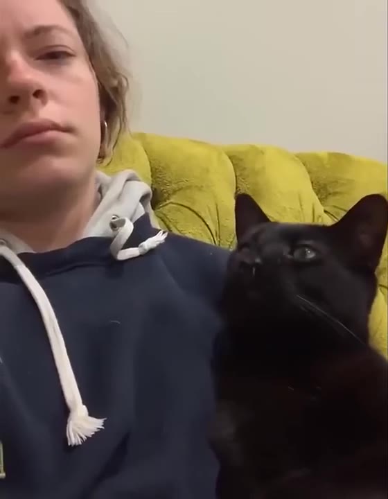 Woman Cuddles Black Cat