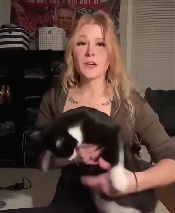 Woman Holds Playful Cat